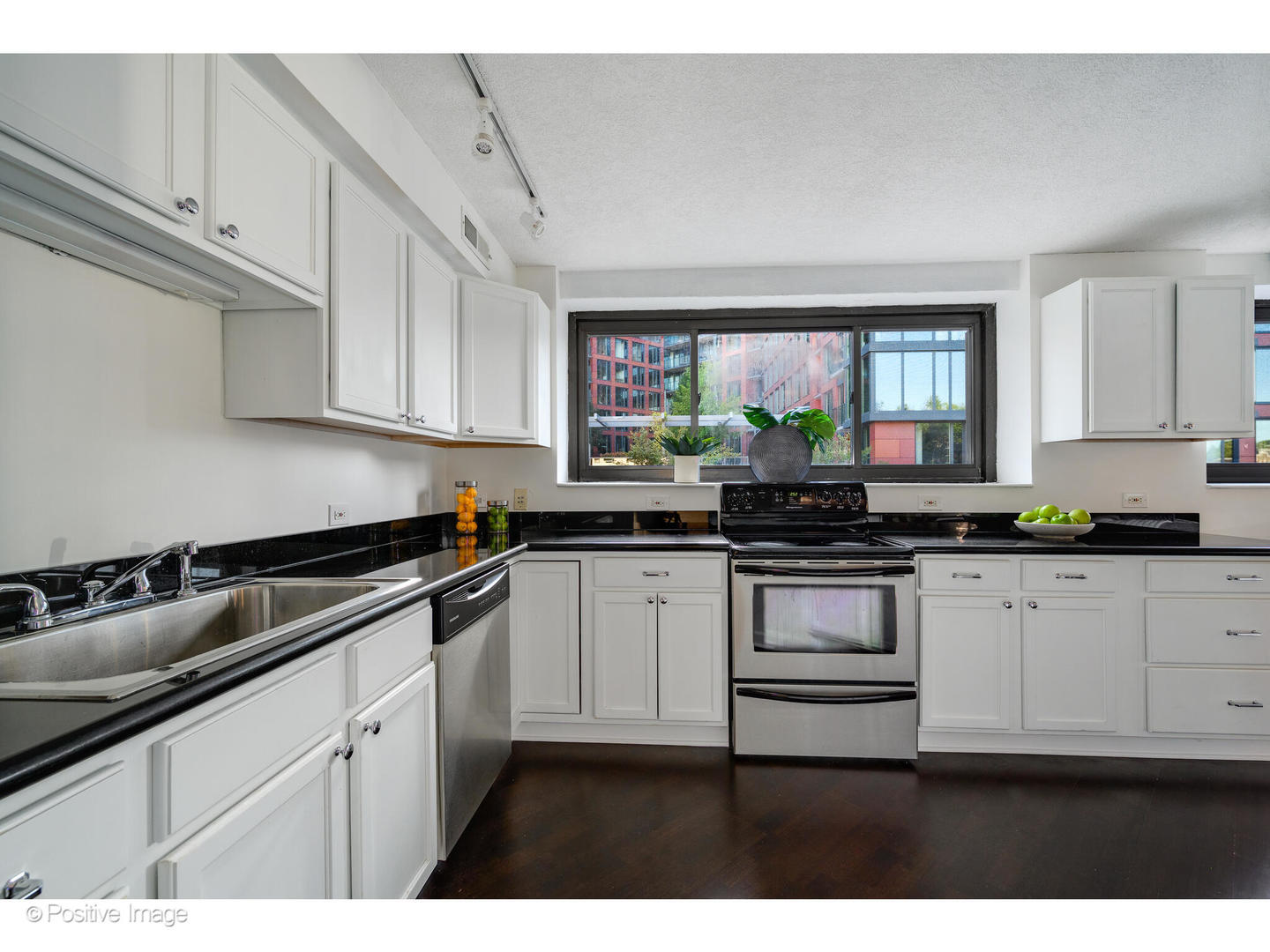 885 West Lill Avenue, Unit 3 Chicago, IL 60614 - Photo 13 of 23 a kitchen with a sink dishwasher a stove and white cabinets