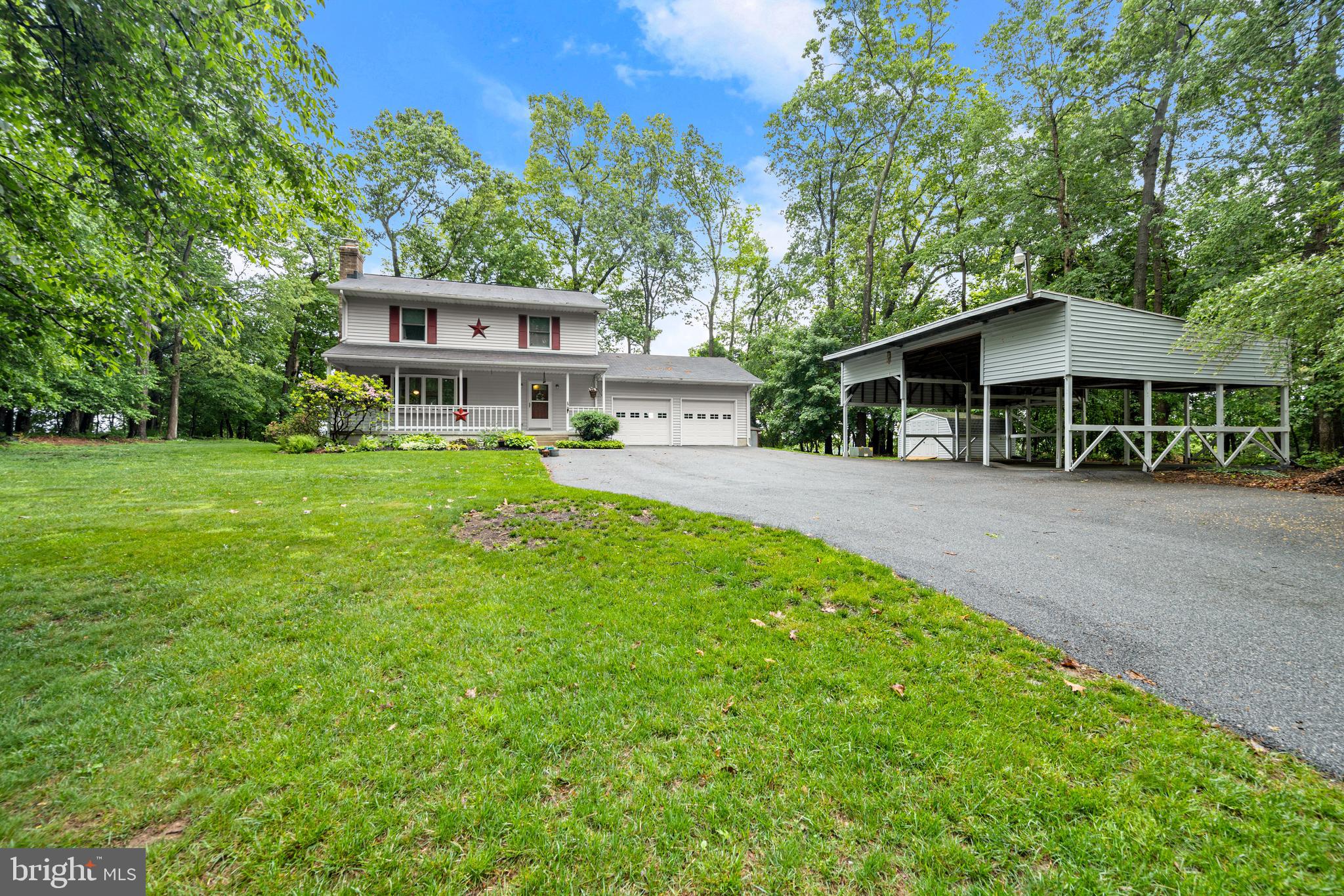5313 Wentz Road Manchester, MD 21102 - Photo 48 of 51 a front view of a house with a garden and trees