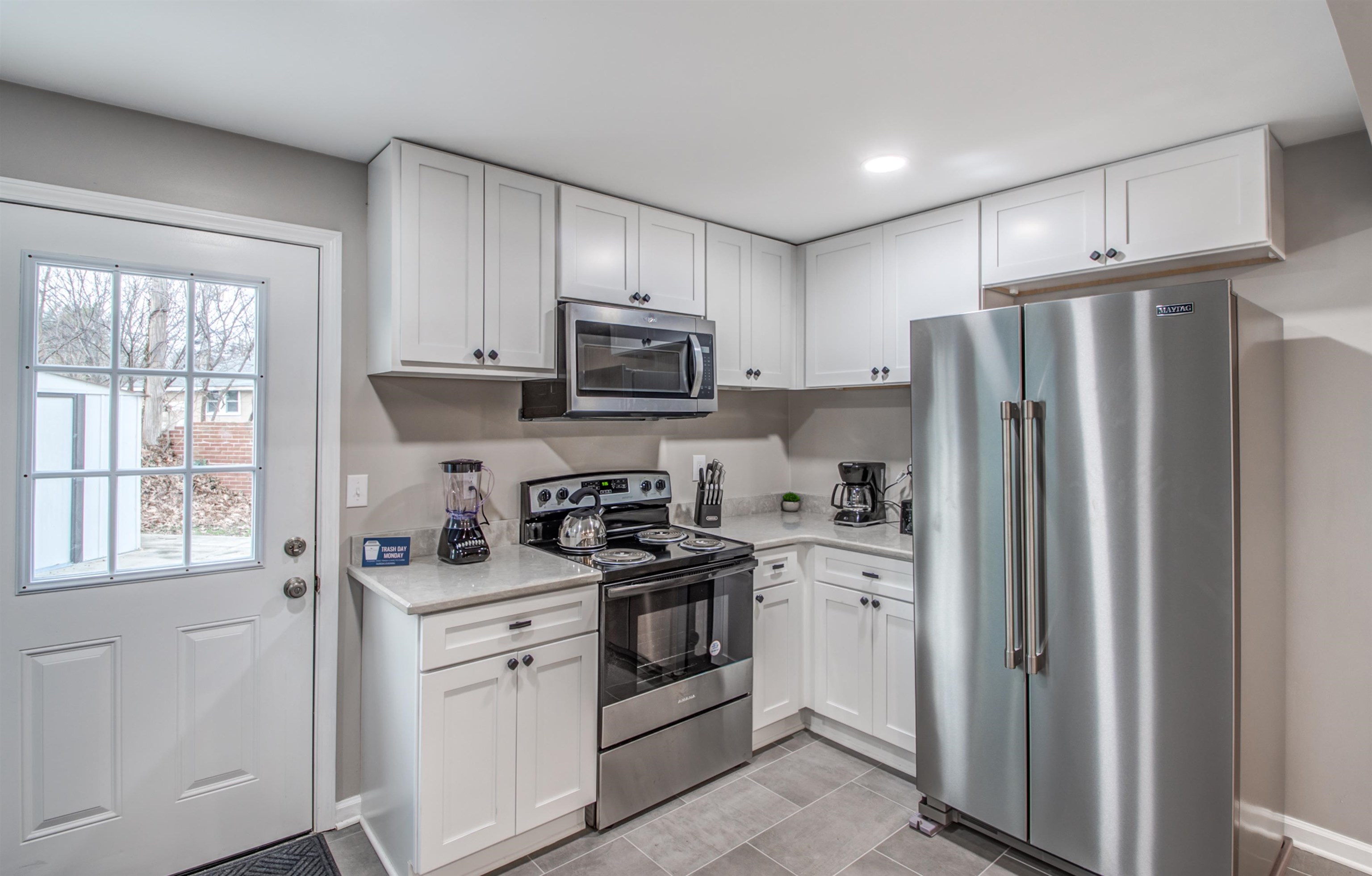 1277 Wellsville Road Memphis, TN 38117 - Photo 19 of 39 a kitchen with stainless steel appliances a refrigerator stove microwave and sink