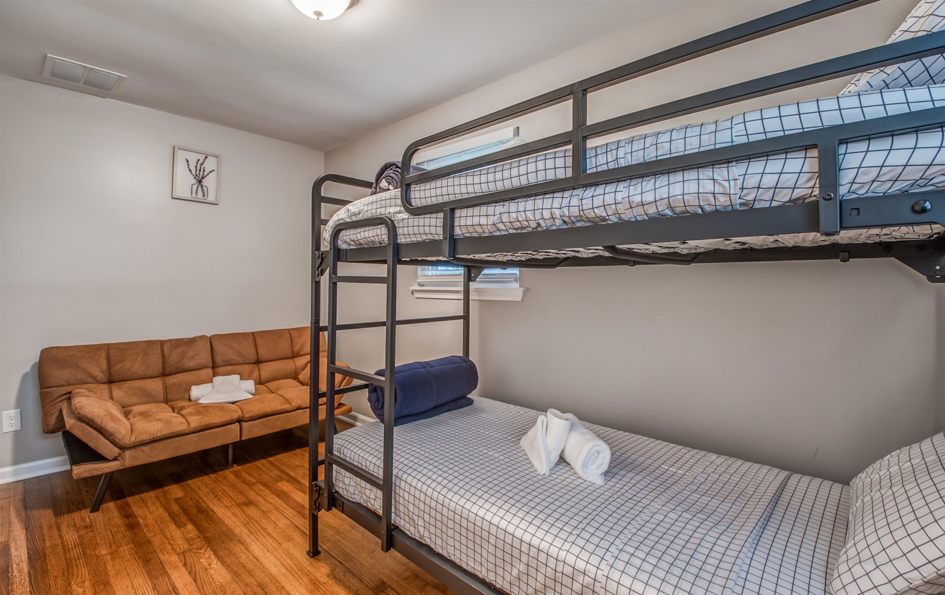 1277 Wellsville Road Memphis, TN 38117 - Photo 20 of 39 a bedroom with a bed and a wooden floor