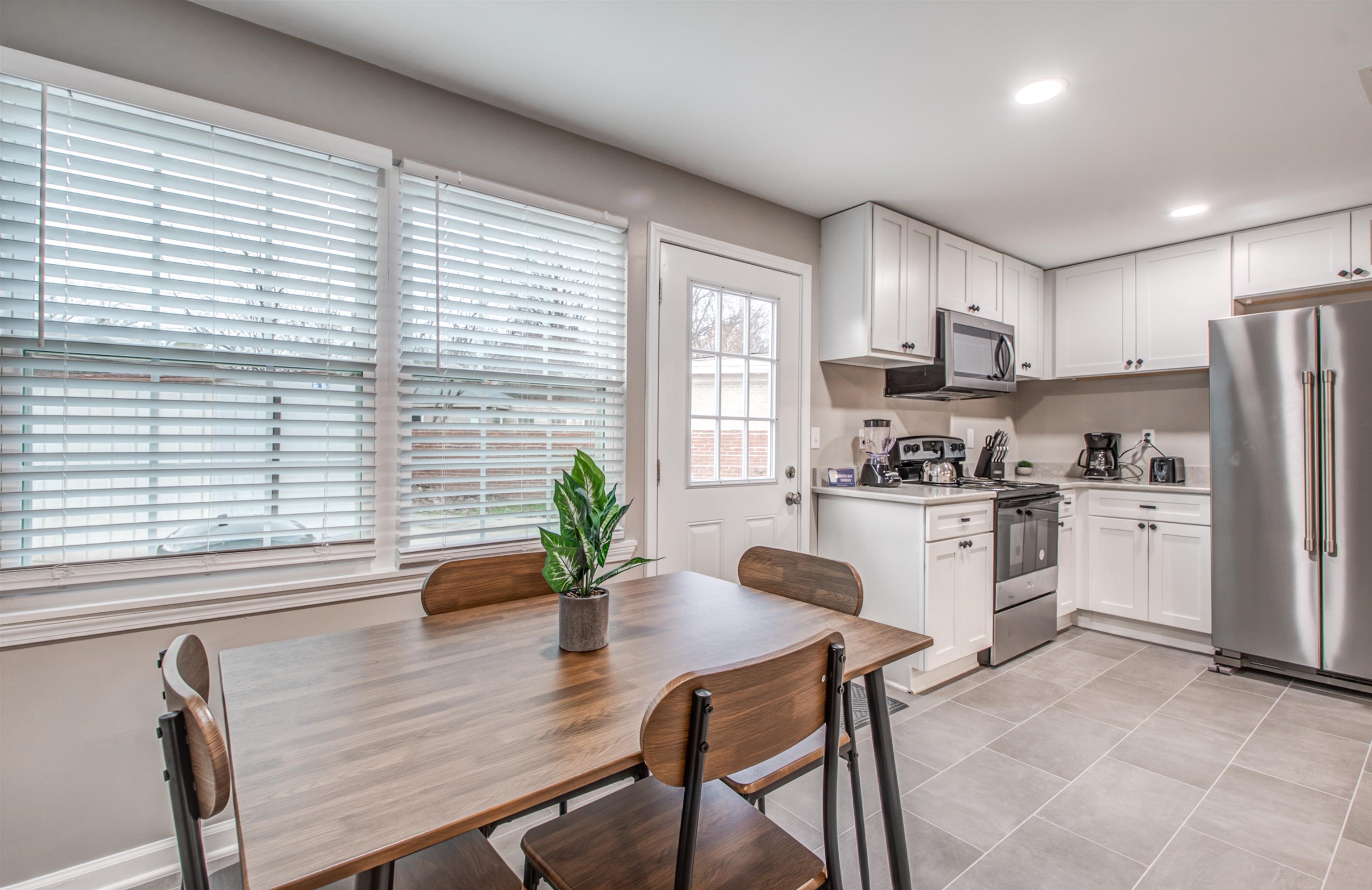 1277 Wellsville Road Memphis, TN 38117 - Photo 25 of 39 Kitchen with light countertops, stainless steel appliances, recessed lighting, white cabinets, and light tile patterned floors