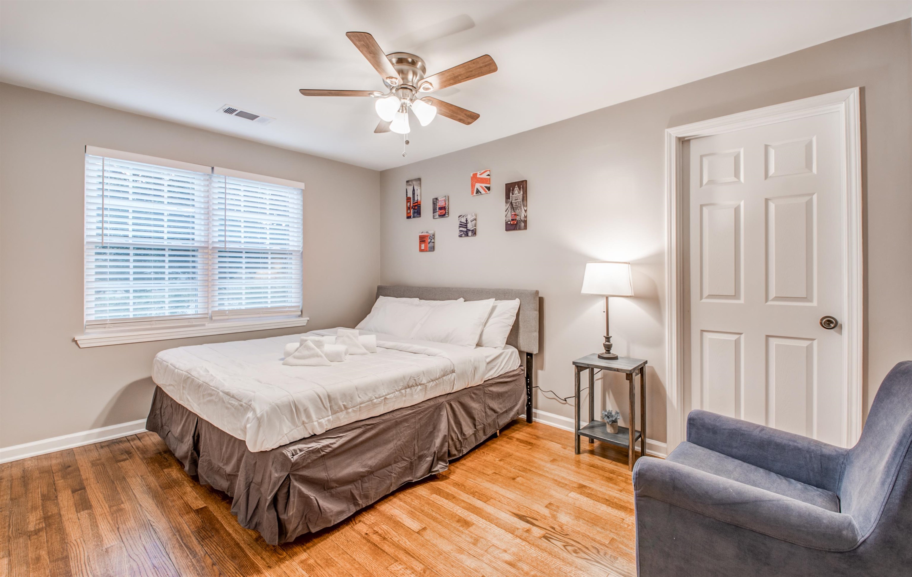 1277 Wellsville Road Memphis, TN 38117 - Photo 27 of 39 a spacious bedroom with a bed and a chandelier