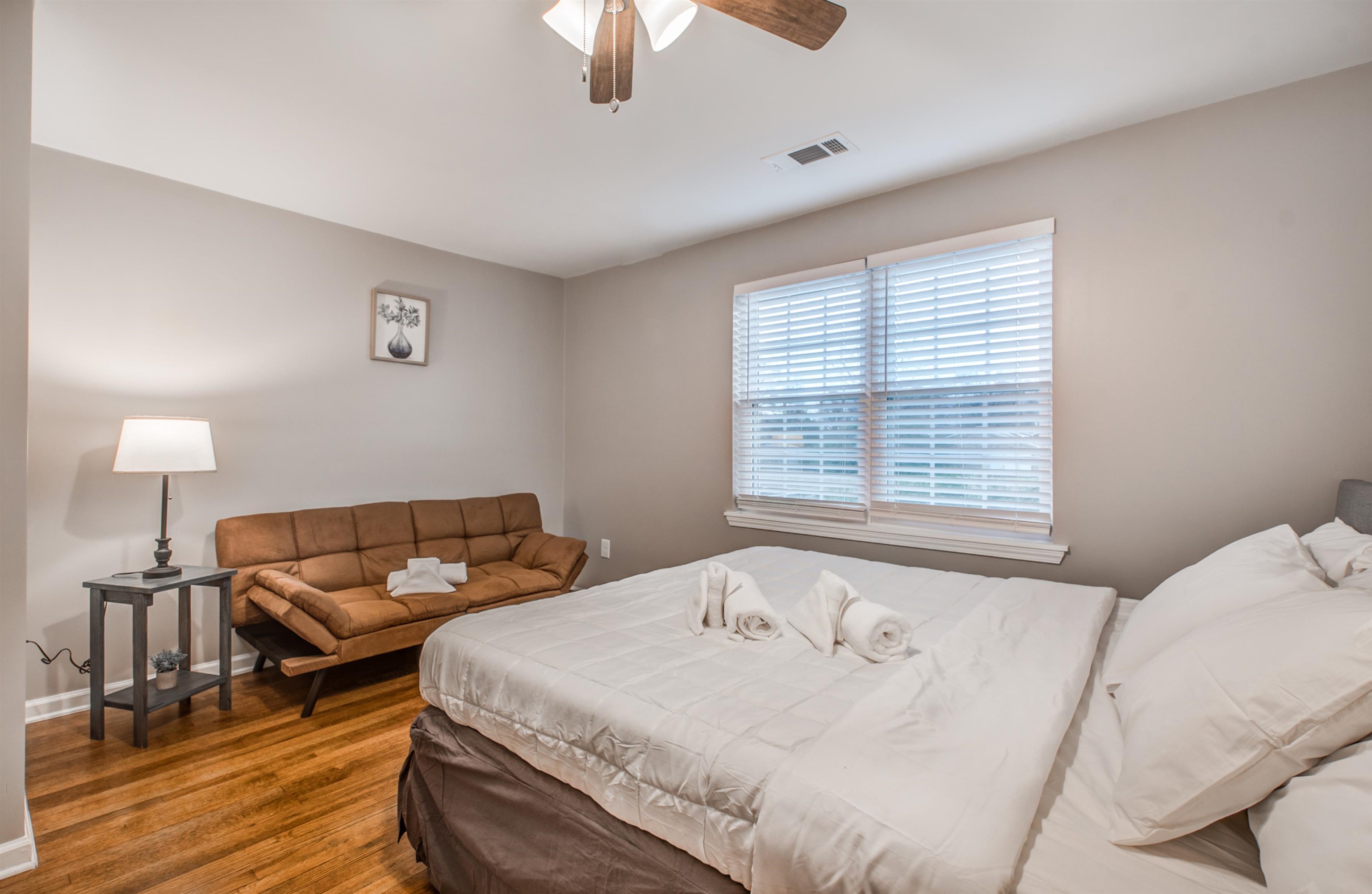 1277 Wellsville Road Memphis, TN 38117 - Photo 28 of 39 a bedroom with a bed and wooden floor