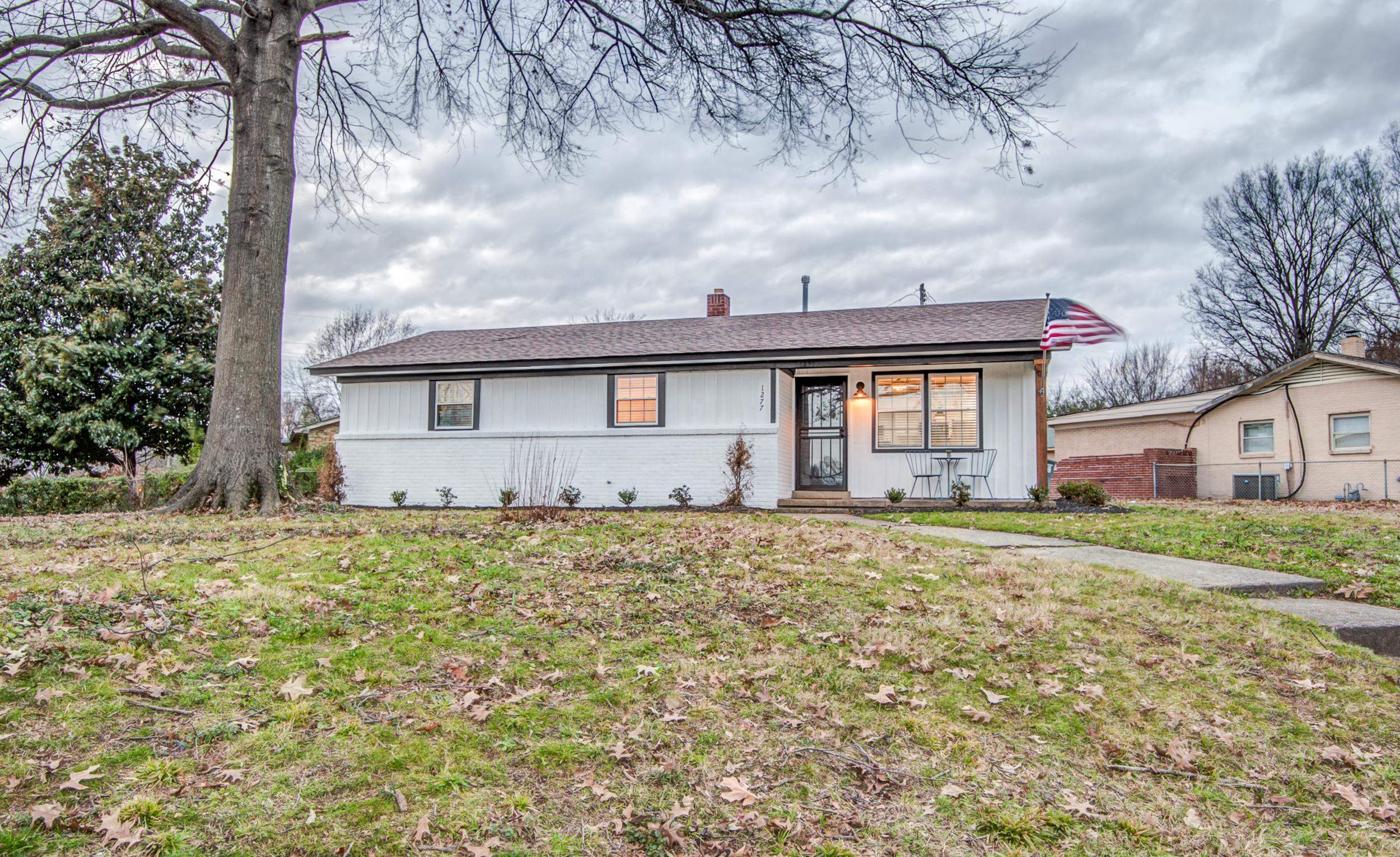 1277 Wellsville Road Memphis, TN 38117 - Photo 4 of 39 a front view of a house with a garden