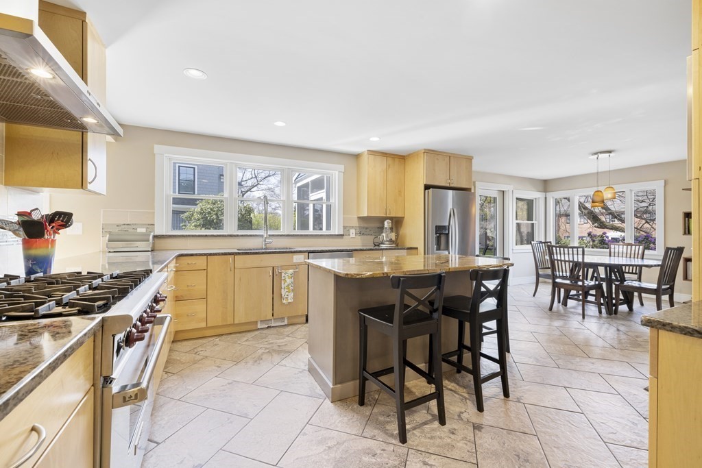 20 Richard Road Lexington, MA 02421 - Photo 5 of 28 a kitchen with granite countertop a stove a sink a dining table and chairs