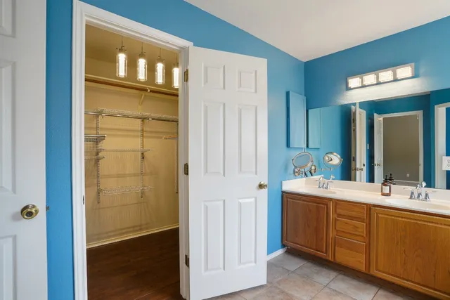 a bathroom with a double vanity sink and a mirror