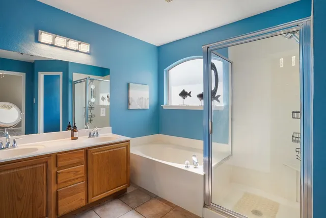a bathroom with a tub sink and mirror