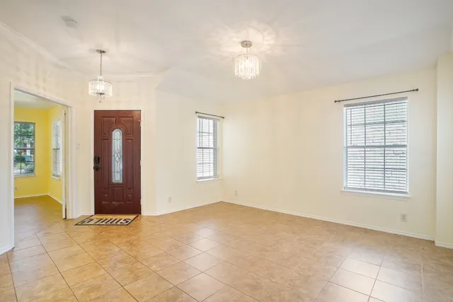 an empty room with windows and closet