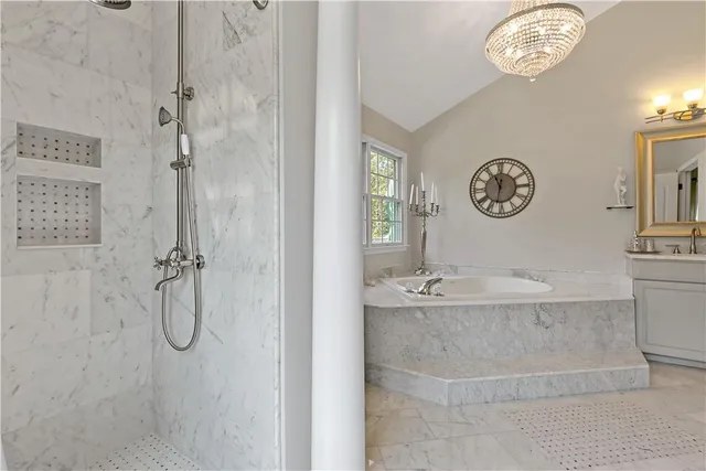 a bathroom with a granite countertop shower a mirror and a sink