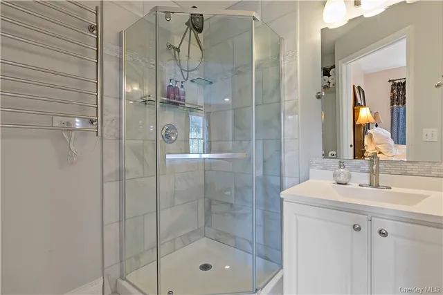 a bathroom with a shower and a sink