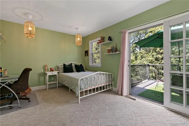 a spacious bedroom with a bed and glass door