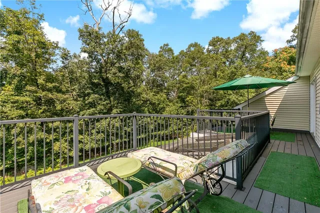 a balcony with table and chairs
