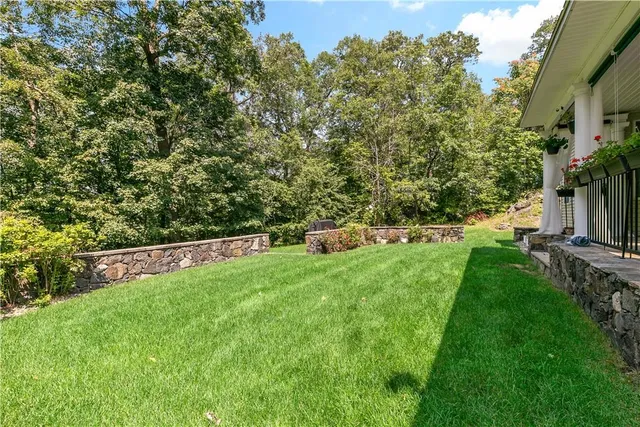 a view of a house with backyard sitting area and garden