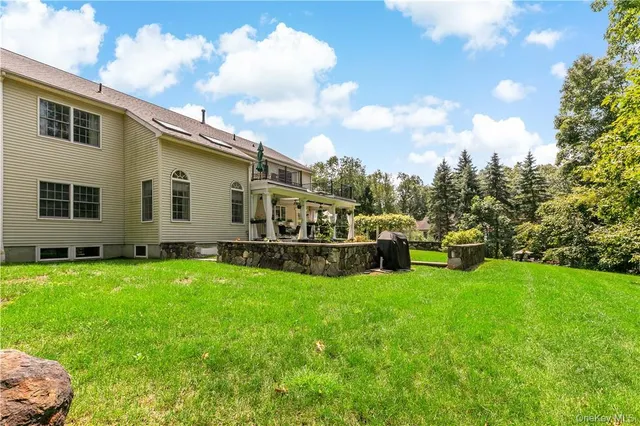 a view of a house with backyard sitting area and garden
