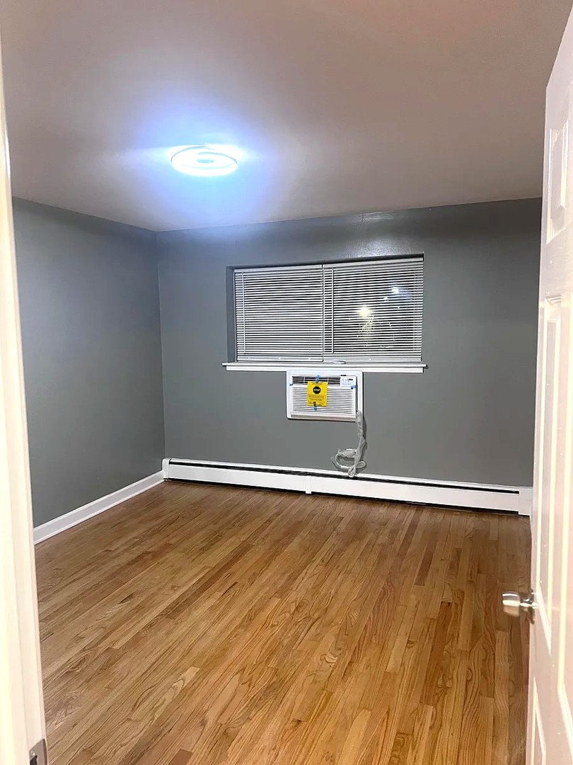 6619 North Sheridan Road, Unit 305 Chicago, IL 60626 - Photo 9 of 10 a view of an empty room with wooden floor