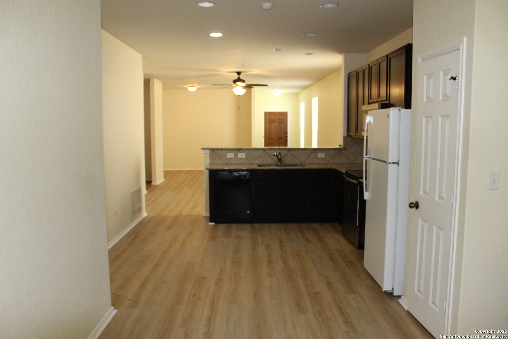 482 Walnut Crest Selma, TX 78154 - Photo 10 of 19 a view of kitchen with refrigerator and wooden floor