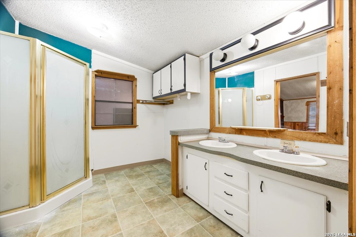 176 Golden Meadows Cibolo, TX 78108 - Photo 13 of 28 a bathroom with a granite countertop sink and a mirror