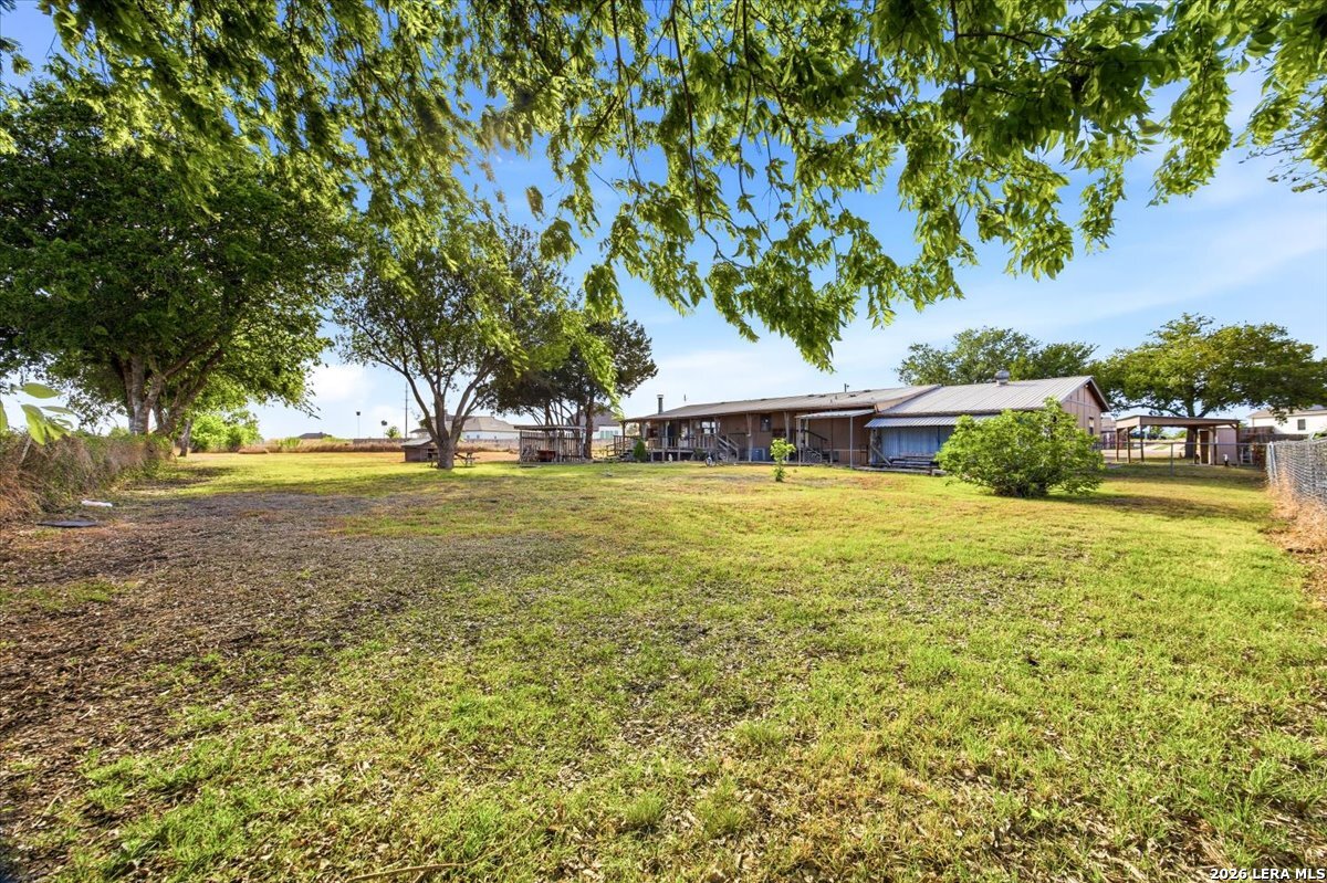 176 Golden Meadows Cibolo, TX 78108 - Photo 16 of 28 a view of a swimming pool with an outdoor space and seating area