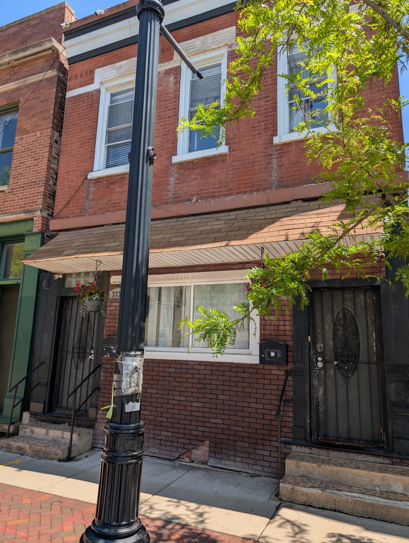3233 South Morgan Street Chicago, IL 60608 - Photo 2 of 14 a view of a house with a door and a window