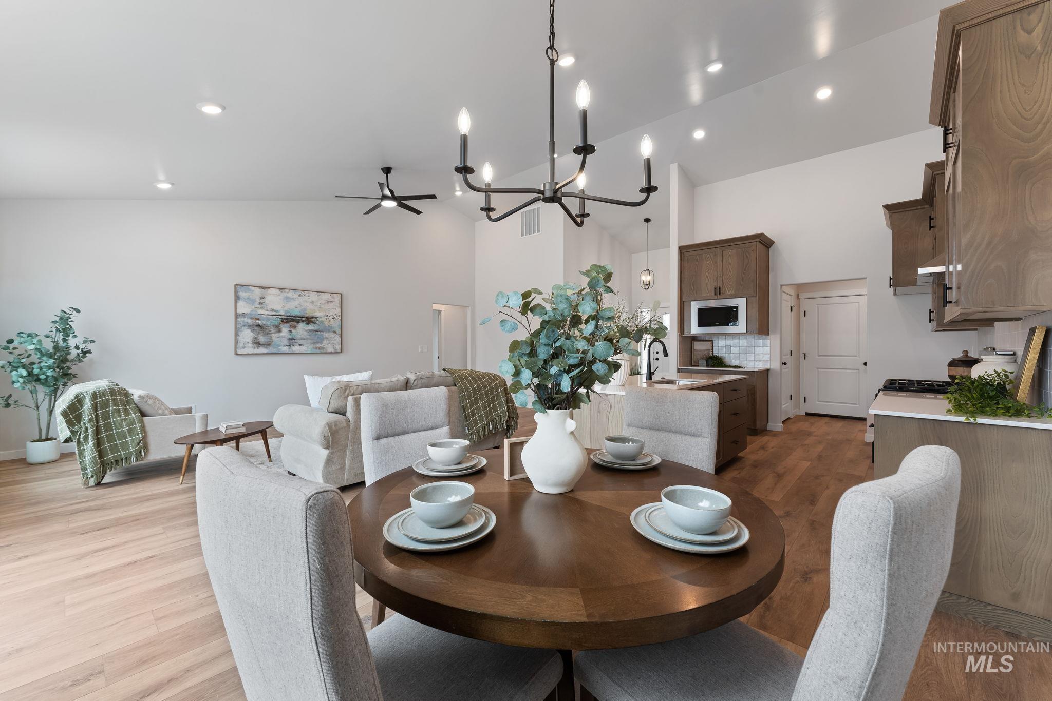 2220 Great Basin Way Burley, ID 83318 - Photo 15 of 39 Dining space with light wood-type flooring, suspended lighting, a ceiling fan, and lofted ceiling