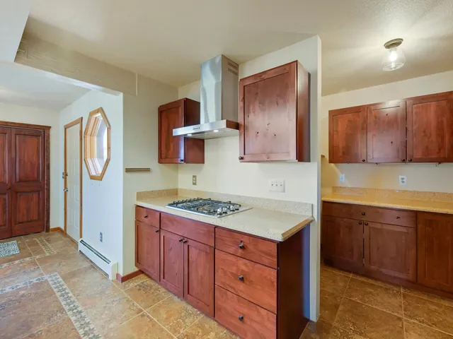 a kitchen with stainless steel appliances granite countertop a sink and wooden cabinets