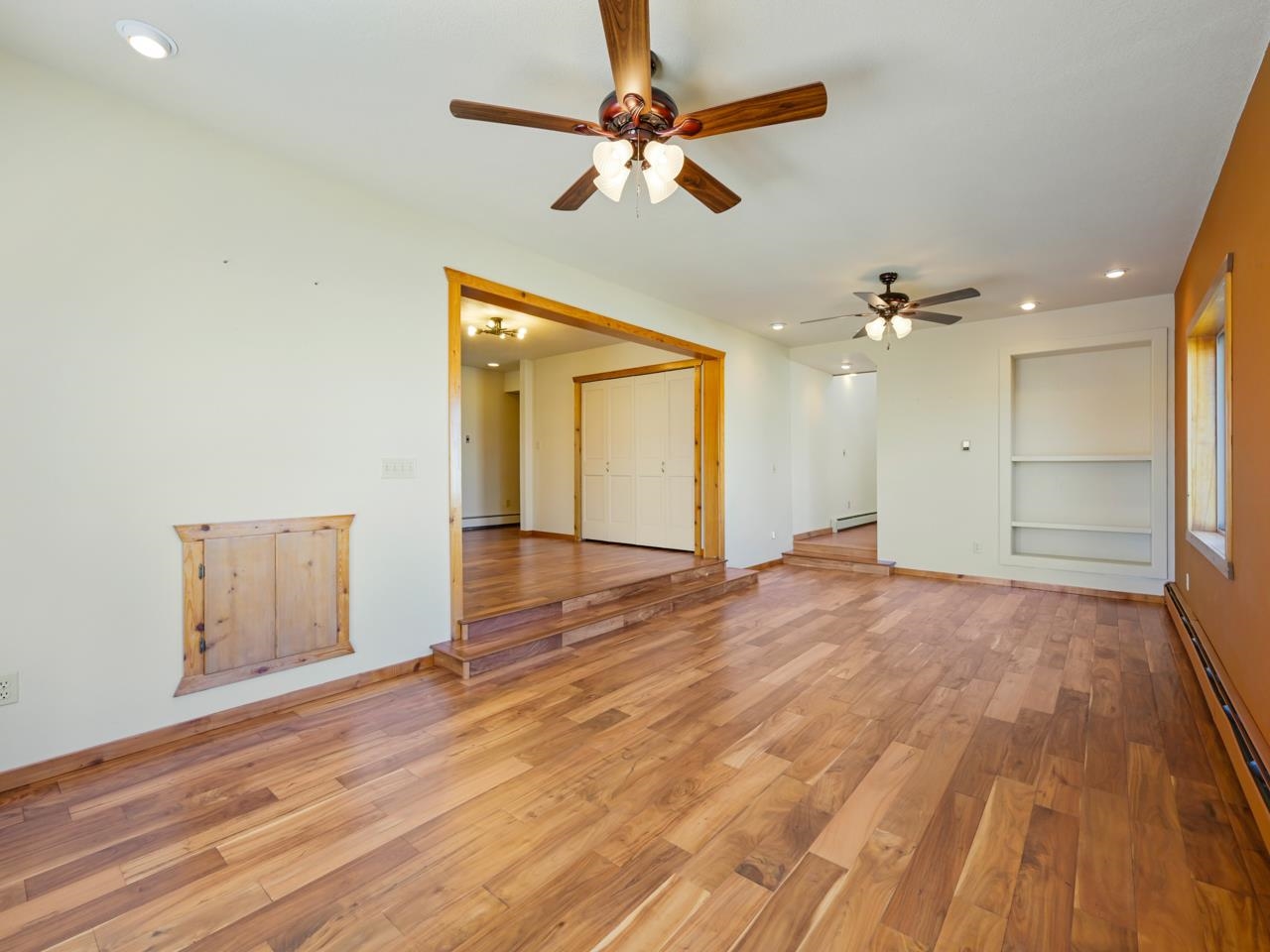 1140-23 23 1/2 Road Grand Junction, CO 81505 - Photo 19 of 42 an empty room with wooden floor chandelier fan and windows