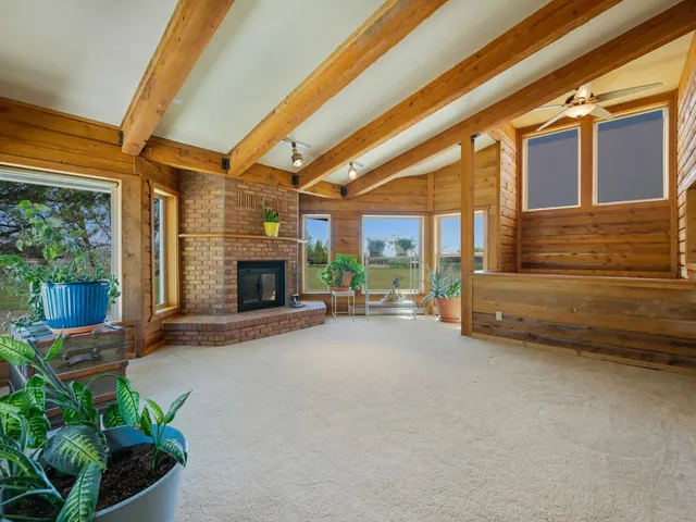 a view of a porch with furniture and a fireplace