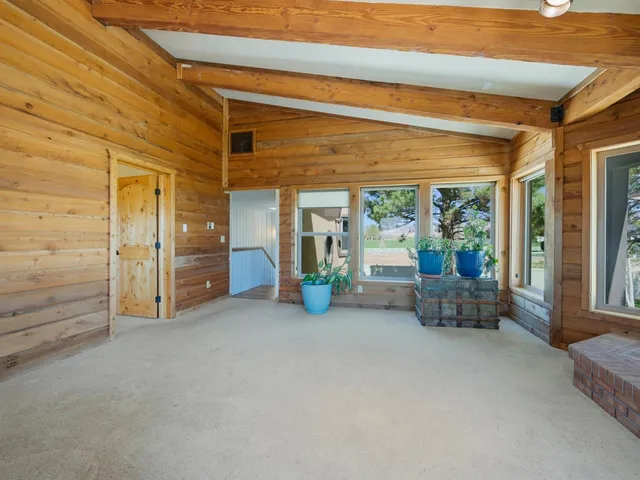 a view of an empty room and floor to ceiling window