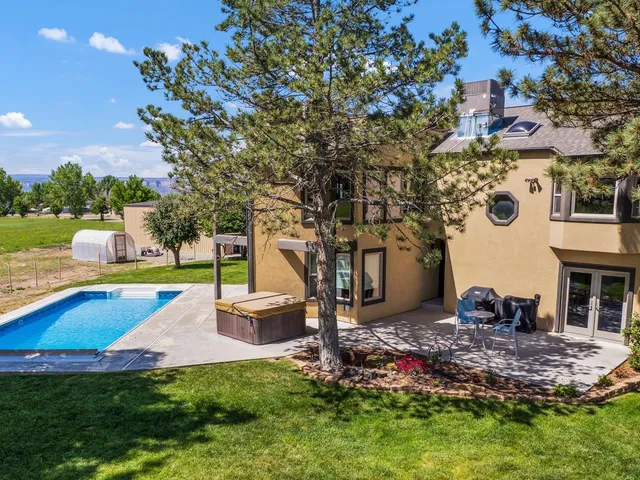 a view of a backyard with a garden and entertaining space