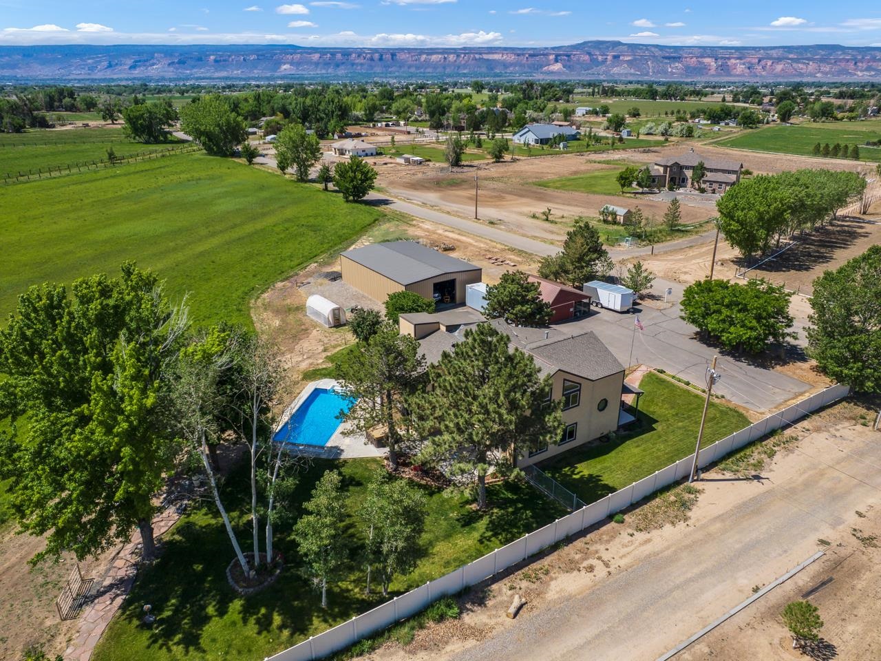 1140-23 23 1/2 Road Grand Junction, CO 81505 - Photo 5 of 42 an aerial view of a house with a garden and mountain view in back