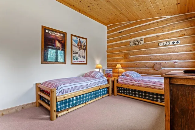 a bedroom with two beds and painted walls
