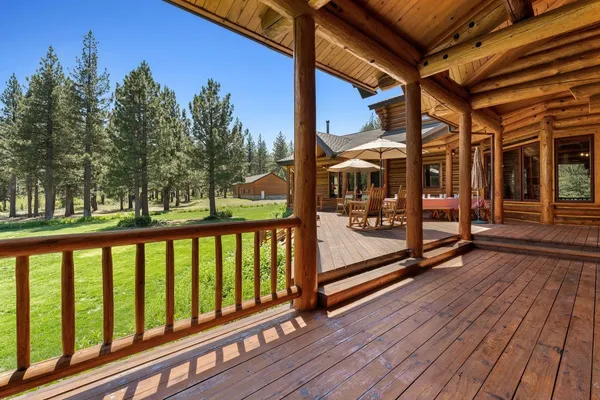 a view of a wooden deck with a yard