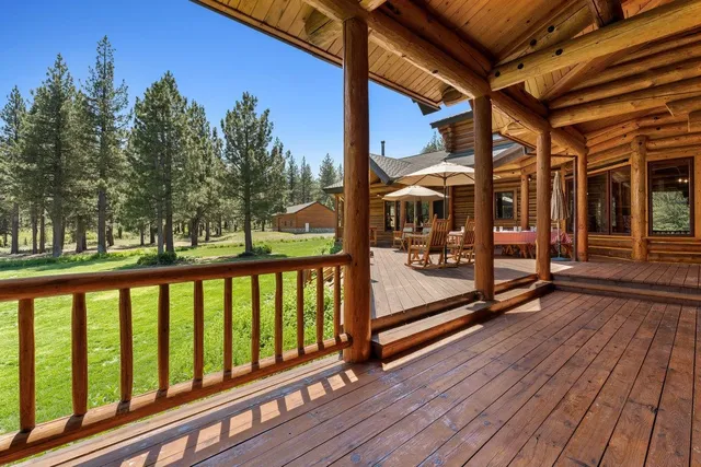 a view of a wooden deck with a yard