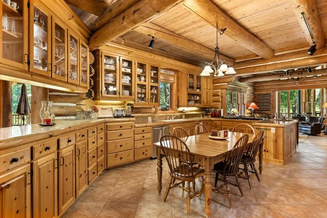 a dining table with chairs and chandelier