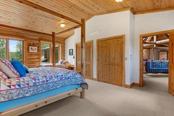 a bedroom with a bed and a chandelier