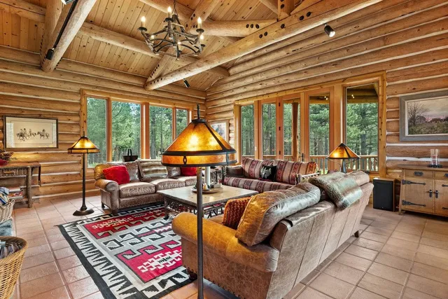a living room with furniture a rug and a chandelier