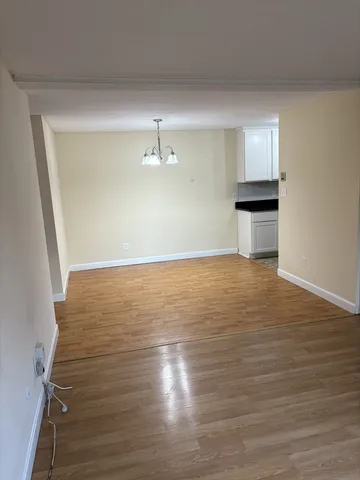 a view of an empty room and wooden floor