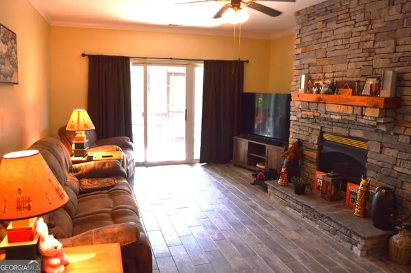 a living room with furniture a flat screen tv and a fireplace