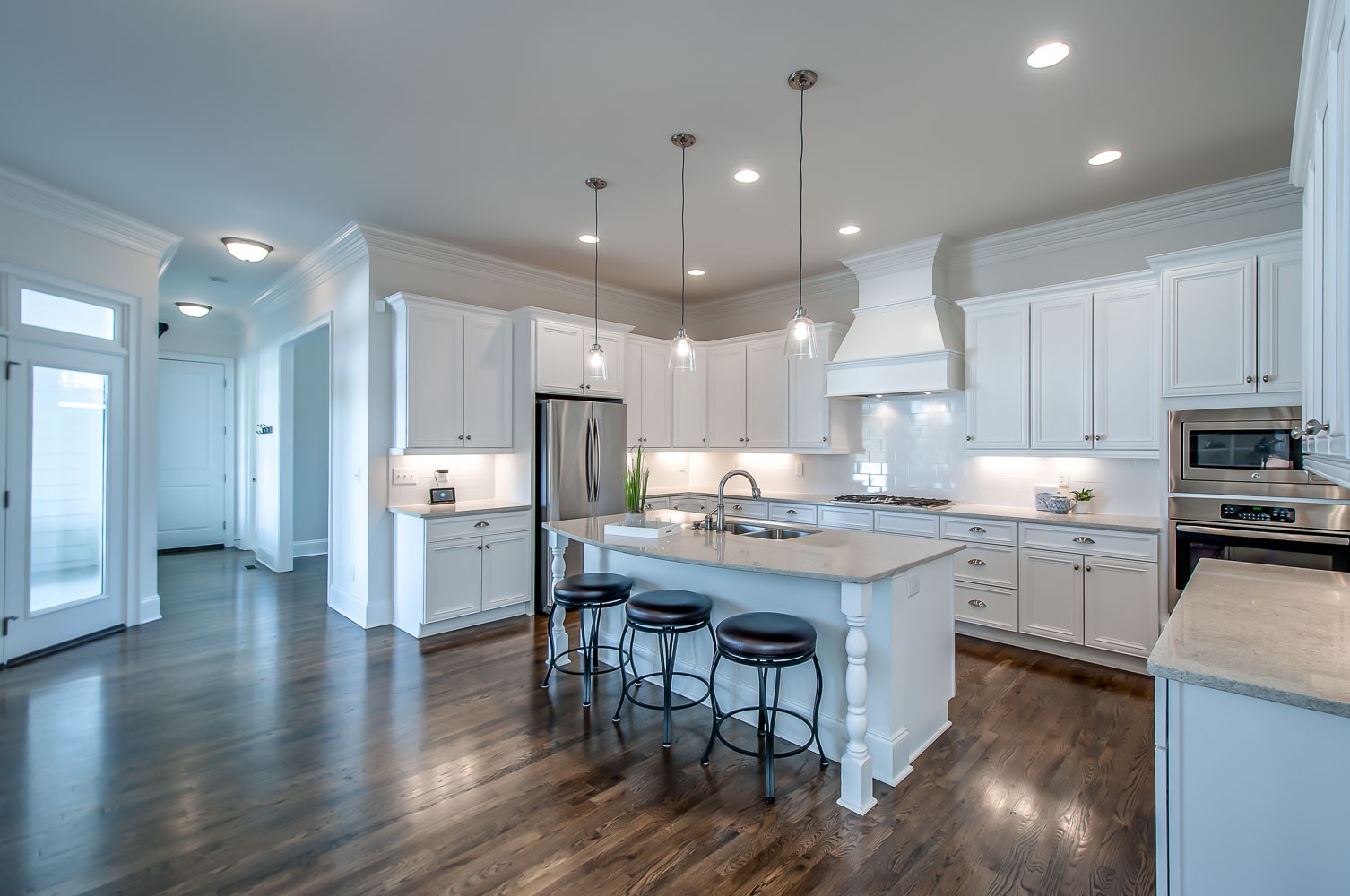 4030 General Martin Lane Franklin, TN 37064 - Photo 6 of 47 a kitchen with stainless steel appliances granite countertop a table chairs sink refrigerator and cabinets