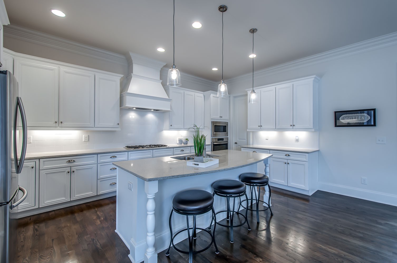 4030 General Martin Lane Franklin, TN 37064 - Photo 7 of 47 a kitchen with kitchen island granite countertop a table chairs sink and cabinets