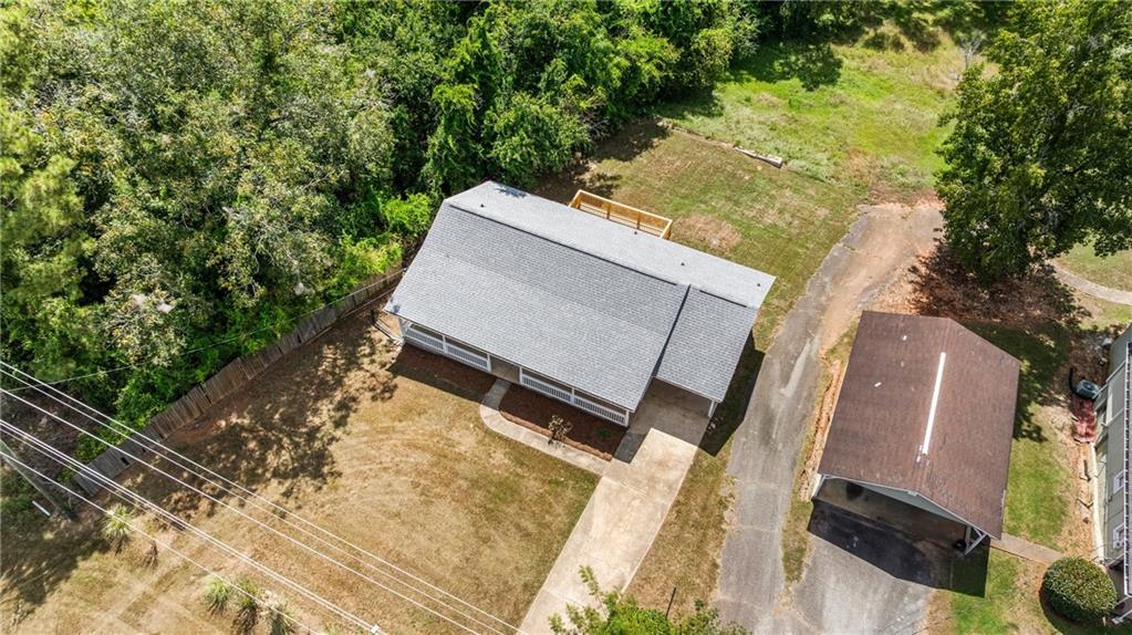 2107 South Seale Road Phenix City, AL 36869 - Photo 30 of 35 Pitched roof structure with a covered front porch, rear deck, concrete driveway, and detached carport