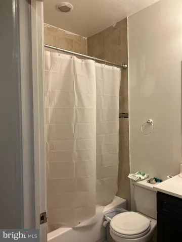 a white toilet sitting next to a shower