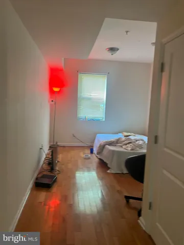 a bedroom with a bed and a potted plant