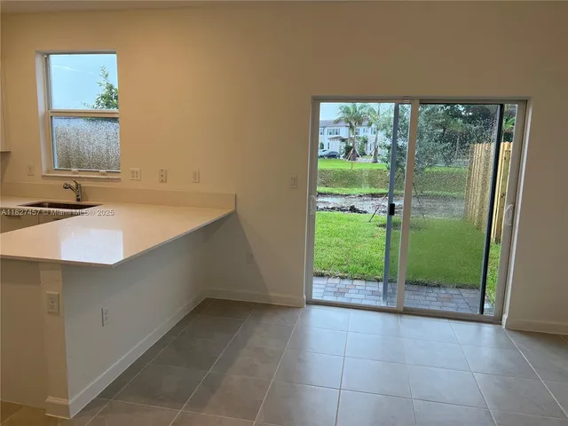 a kitchen with stainless steel appliances a sink stove and cabinets