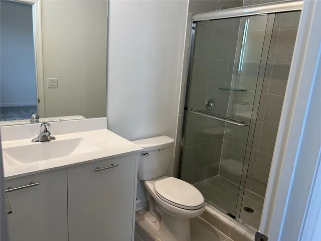 a bathroom with a shower and toilet