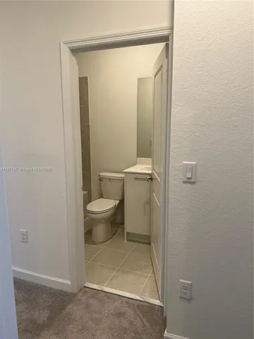a bathroom with a toilet sink and shower