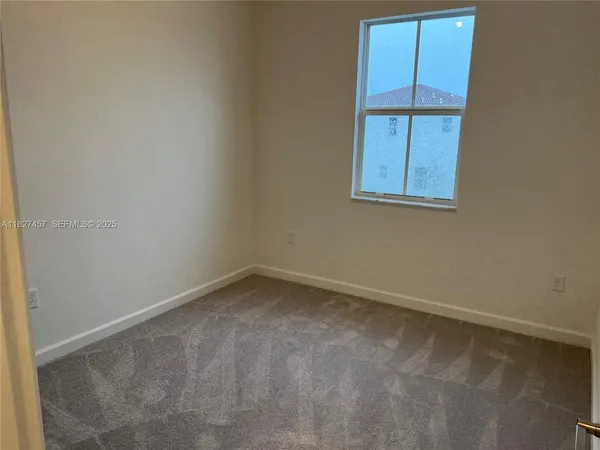 an empty room with closet and a bathroom view