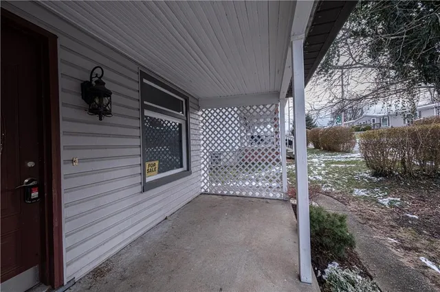 a view of a house with a yard next to a house