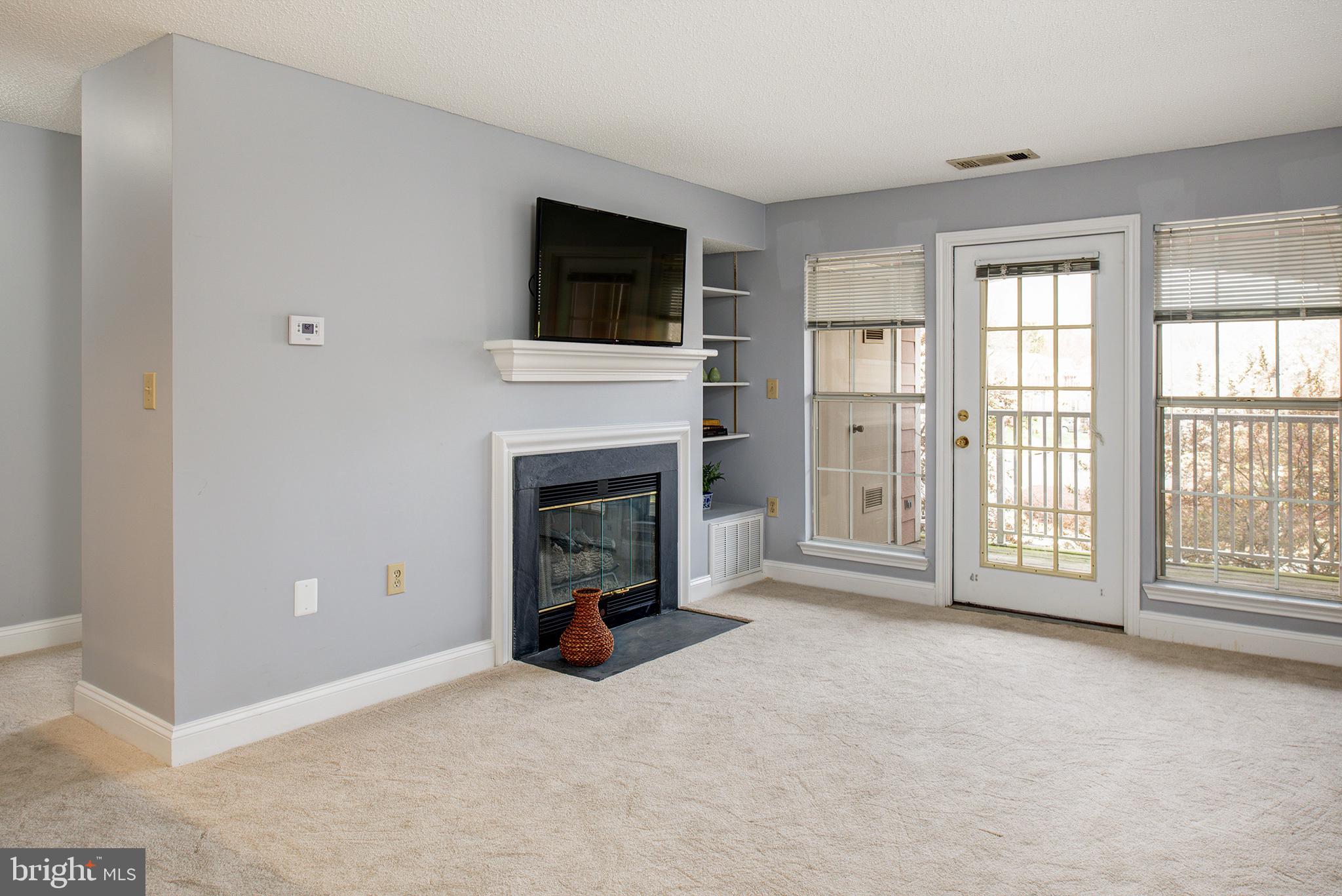 20951 Timber Ridge Terrace, Unit 202 Ashburn, VA 20147 - Photo 13 of 16 Family room opens to the private balcony