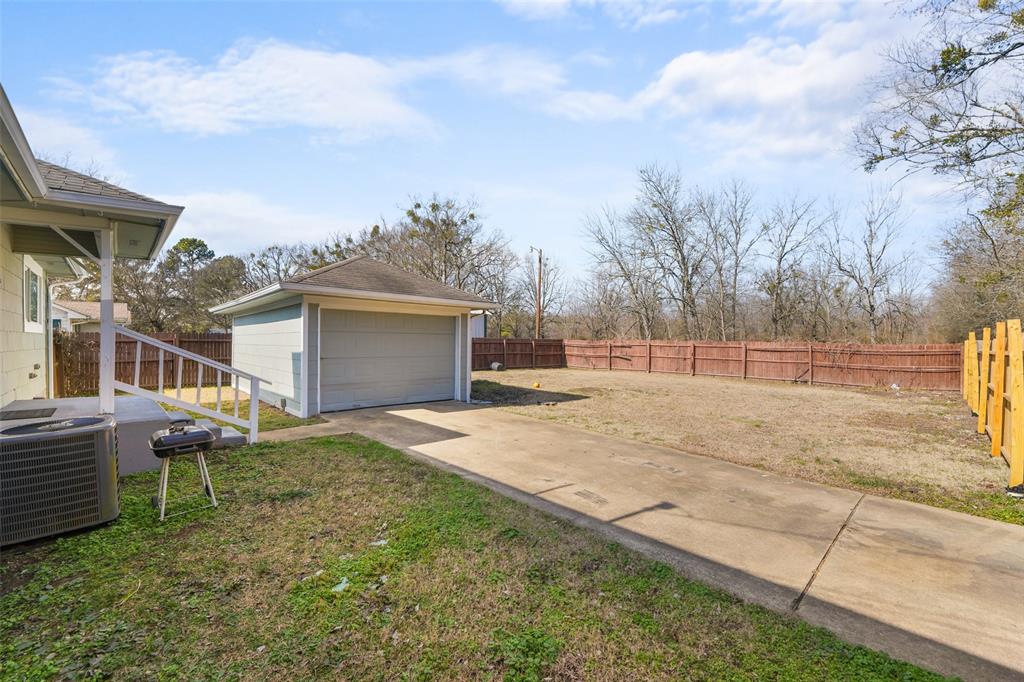 1145 Jefferson Road Paris, TX 75460 - Photo 16 of 17 a backyard of a house with table and chairs
